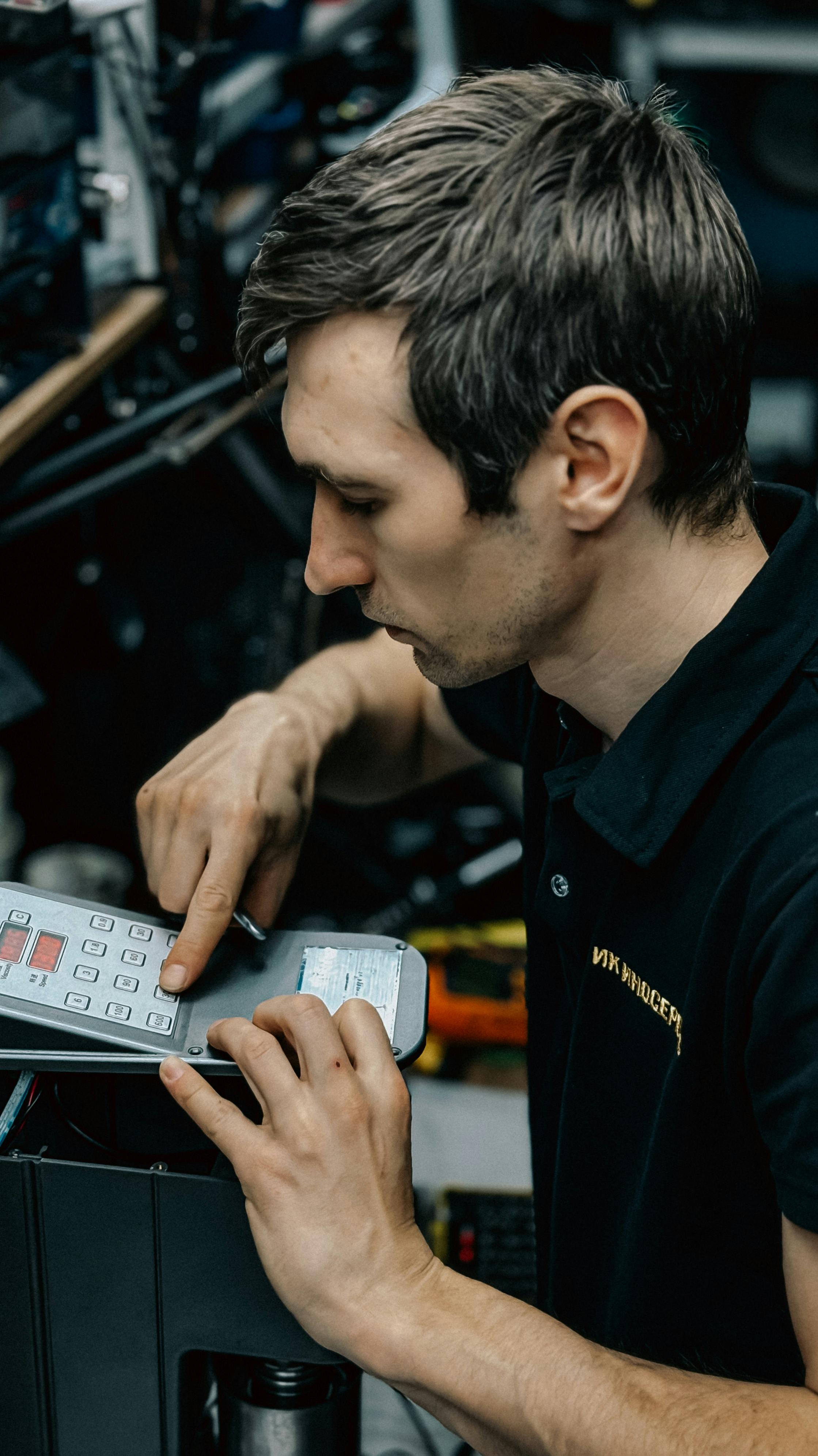 Professional technician fixing office equipment, focusing on control panel. Perfect for business and technology themes.